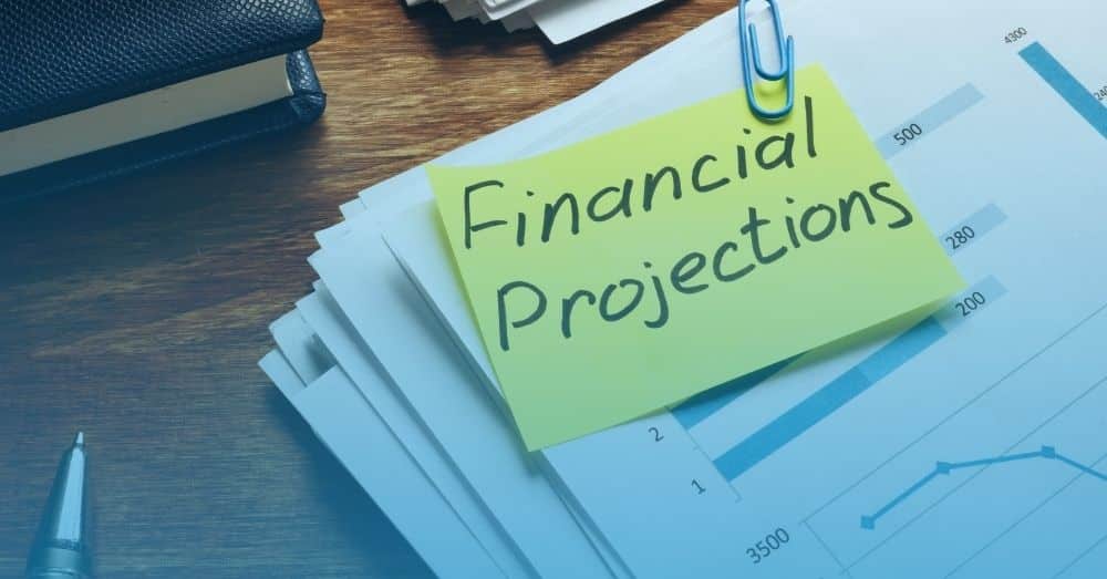 strategic accounting and financial projections on paper and post-it note with blue background