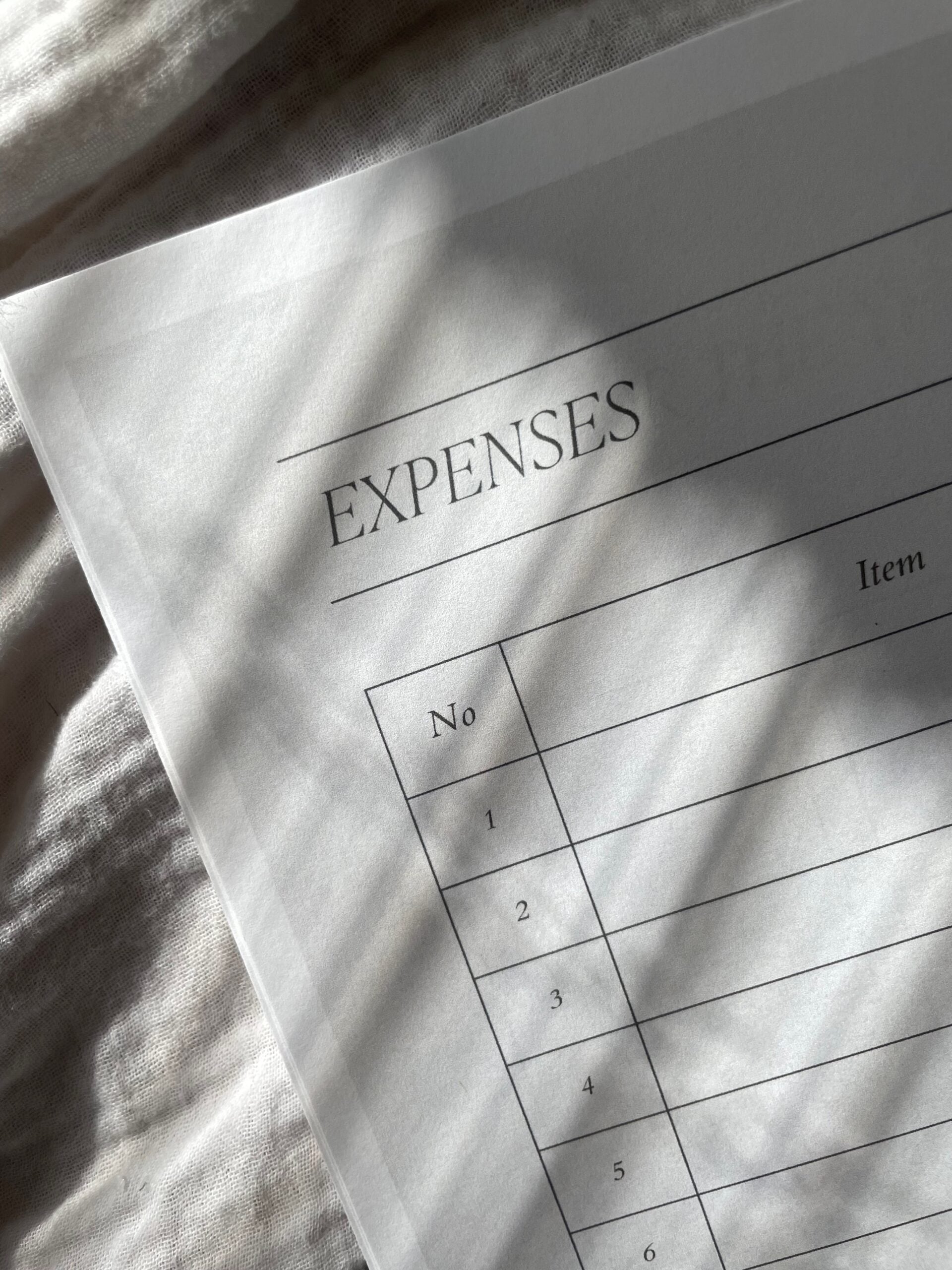 paper with expenses at the top and a place to list them out