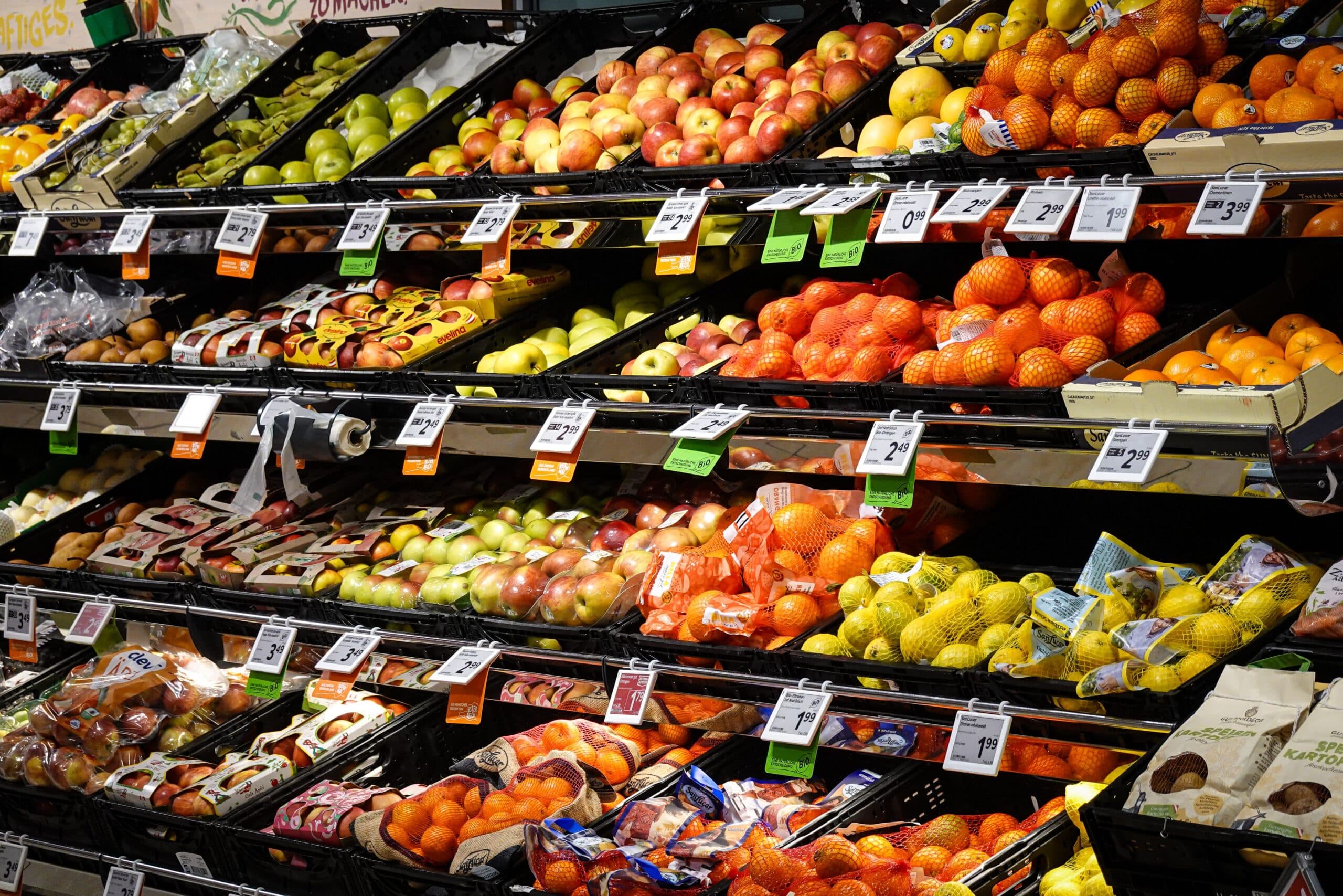 grocery store shelves of fruits with different price tags