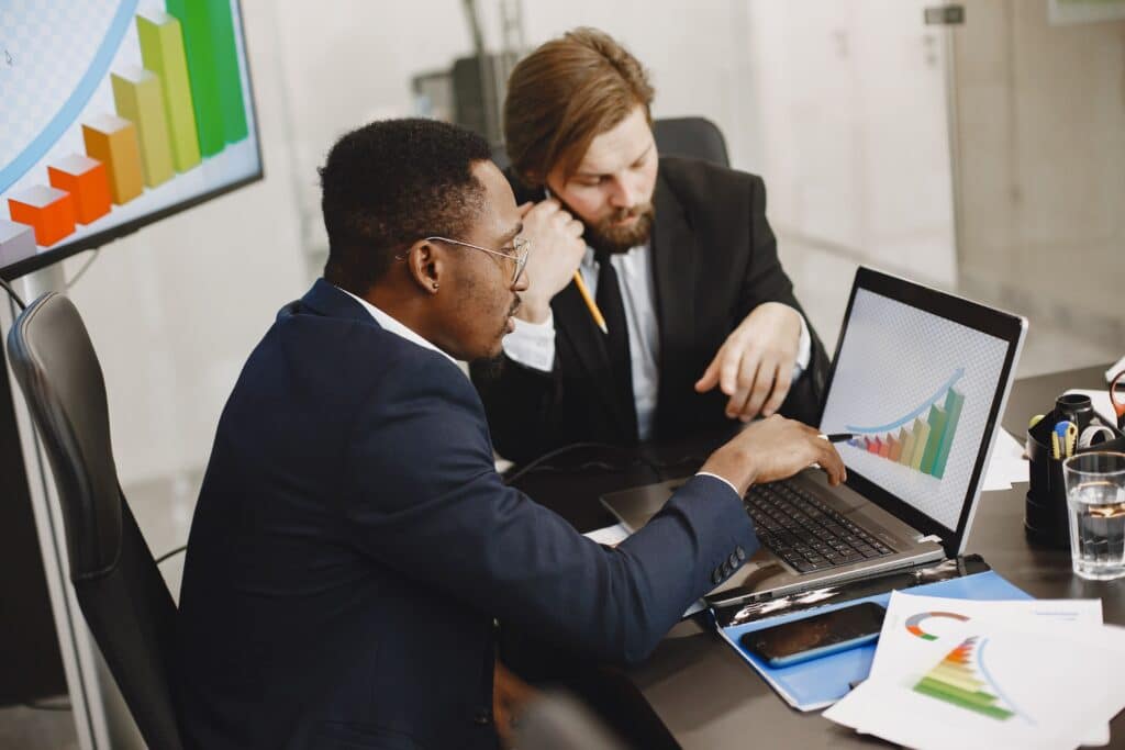small business owner meeting with business cfo catalyst and reviewing financial documents